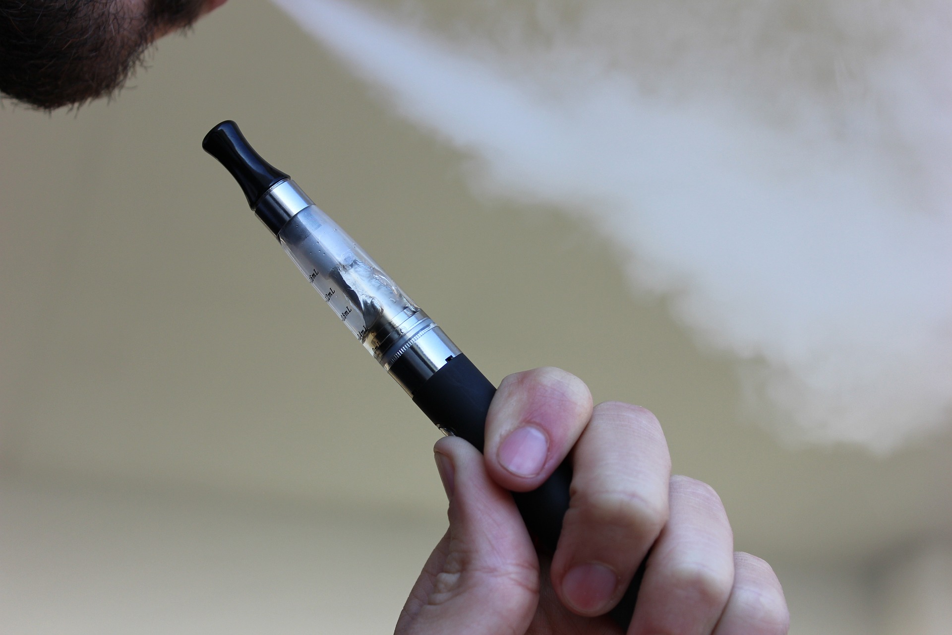 Closeup of vape pen being smoked by man