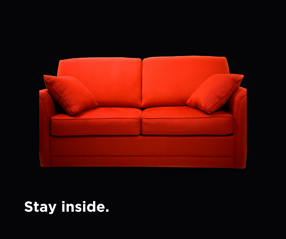 Closeup of red couch with caption "Stay inside"