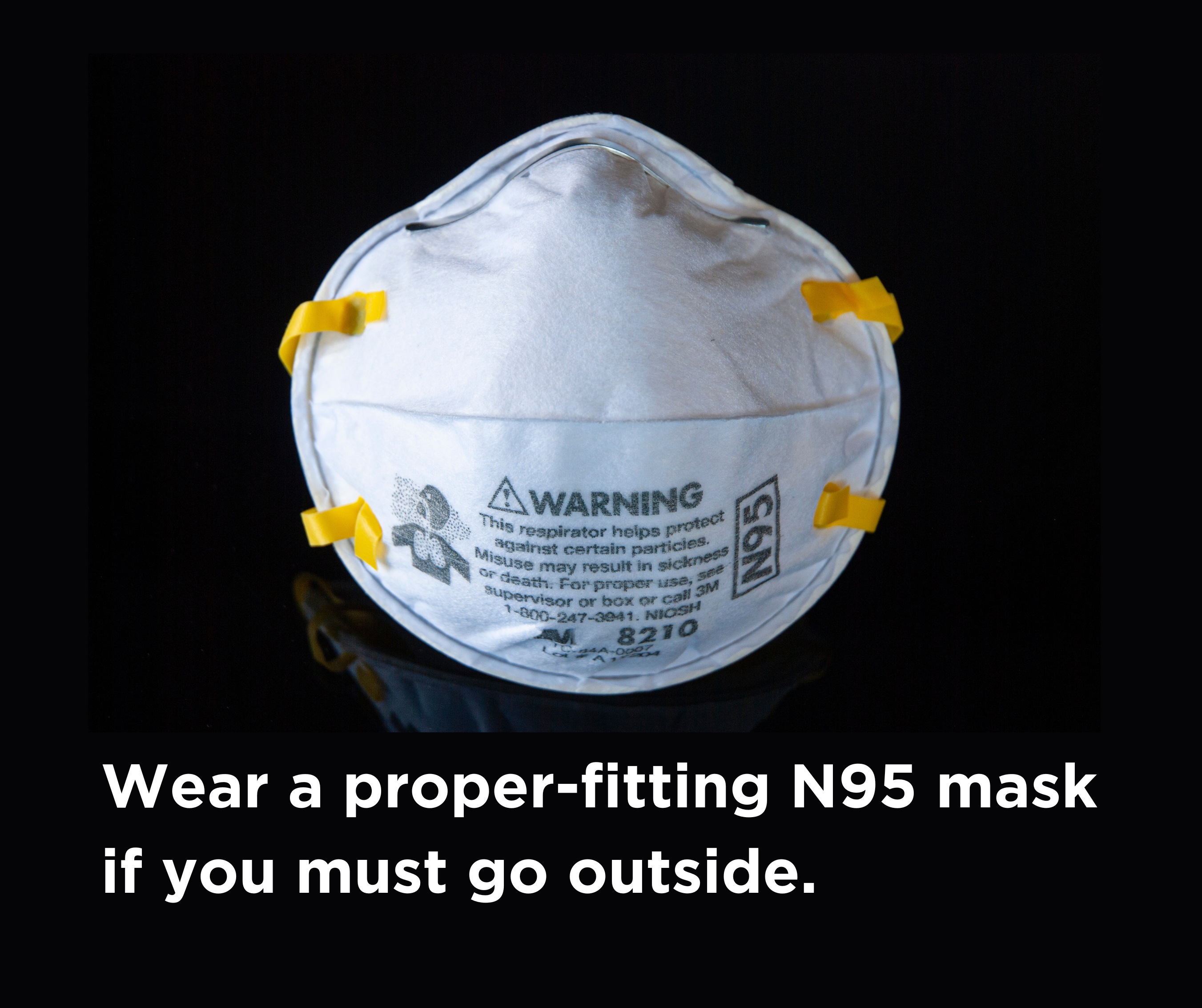 Closeup of N95 respirator mask with caption "Wear a proper-fitting N95 mask if you must go outdoors.".