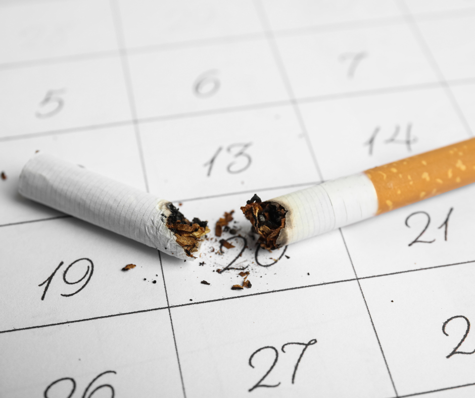 Quit day: Closeup of broken cigarette on calendar