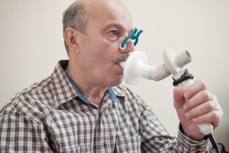 Man breathing into a spirometry machine