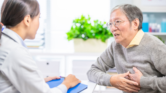 Older man sitting across from doctor